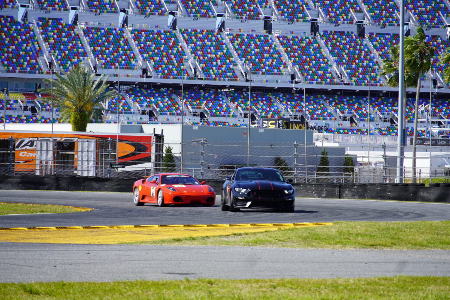 Ferrari and Mustang battling through Daytona infield
