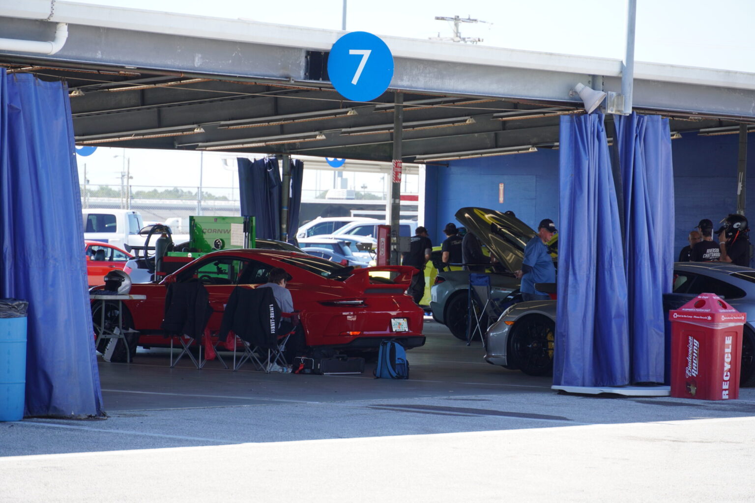 People working in the Daytona paddock garages