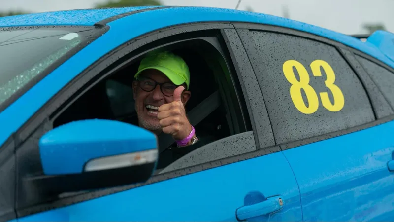Steve Fureman giving a thumbs up from inside his race car